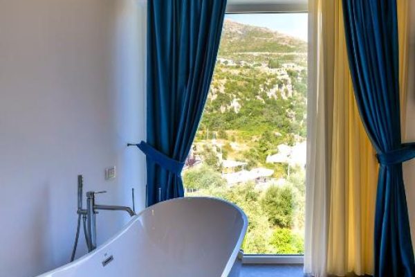 Blue Boutique Hotel in Albania bathtub with a beautifull view of the mountain