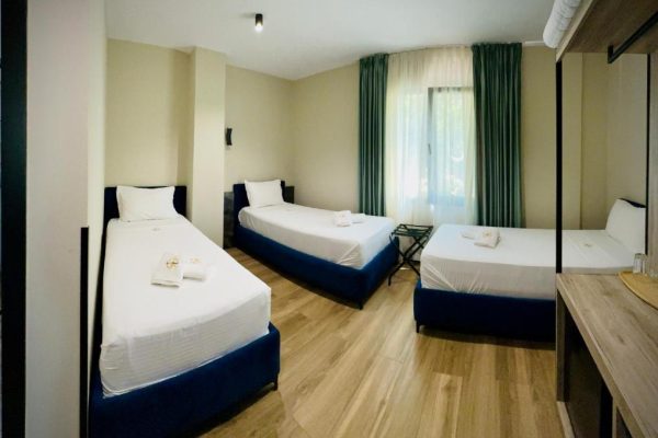 gogo's boutique hotel with three single beds and all the other necessities